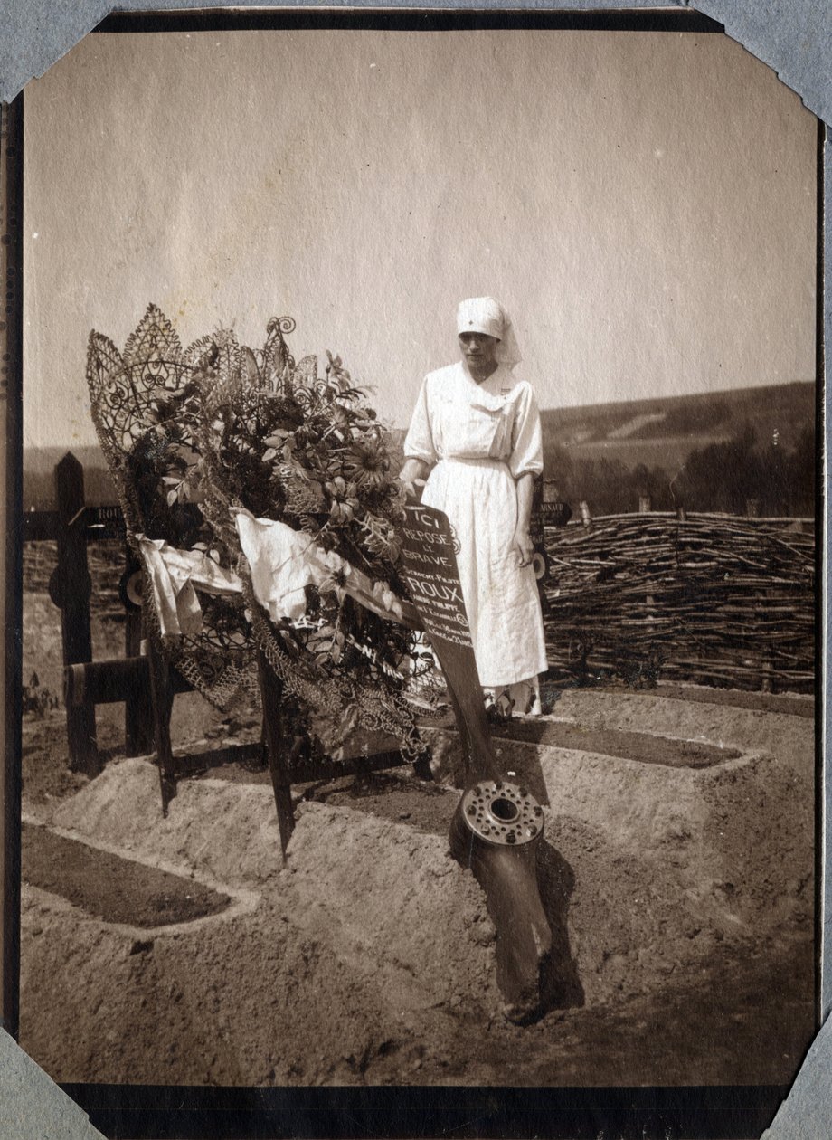 První světová válka 1914-1918: zdravotní sestra (Therese Pavillou?) v blůze na hrobě francouzského pilota seržanta Rouxe, který zemřel ve věku 21 let v Couville, Manche, Basse-Normandie (Dolní Normandie), Francie. Anonymní fotografie červenec 1917. Soukrom od Anonymous Anonymous