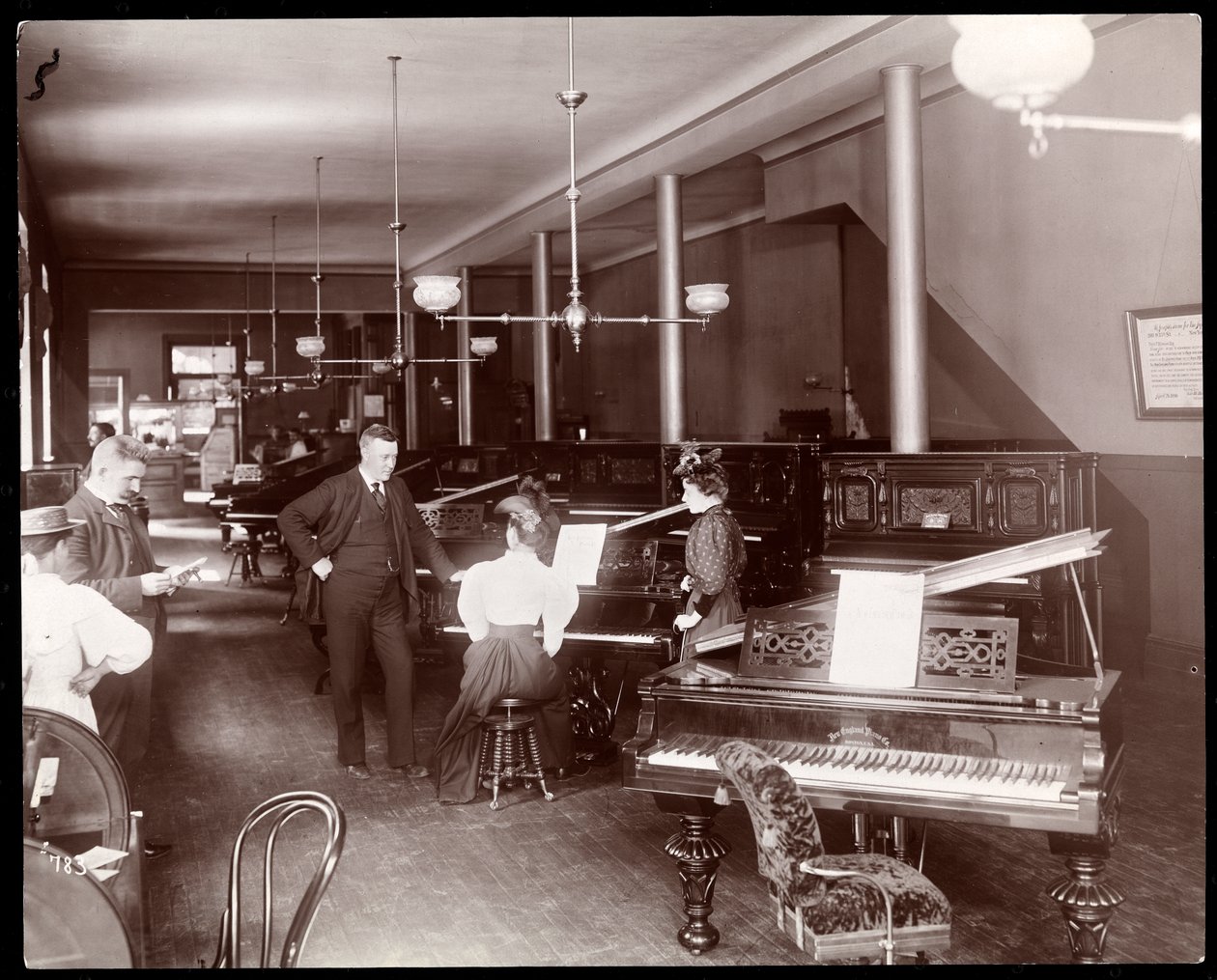 Showroom společnosti New England Piano Co., 1895 (stříbrný želatinový tisk) od Byron Company