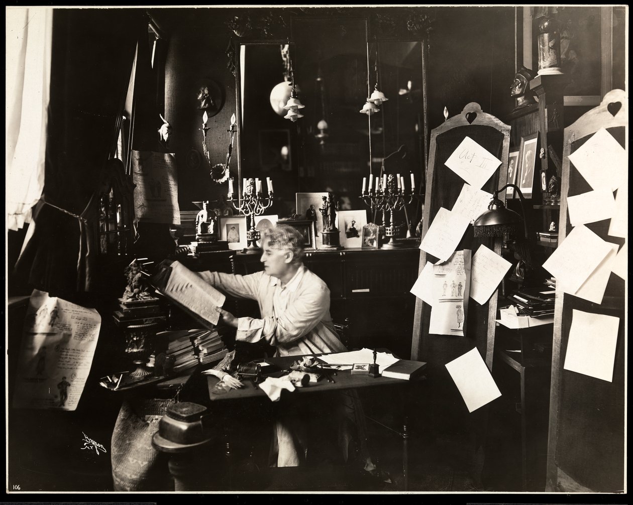 David Belasco ve své pracovně, listování ve slovníku, 1909 (stříbrný želatinový tisk) od Byron Company