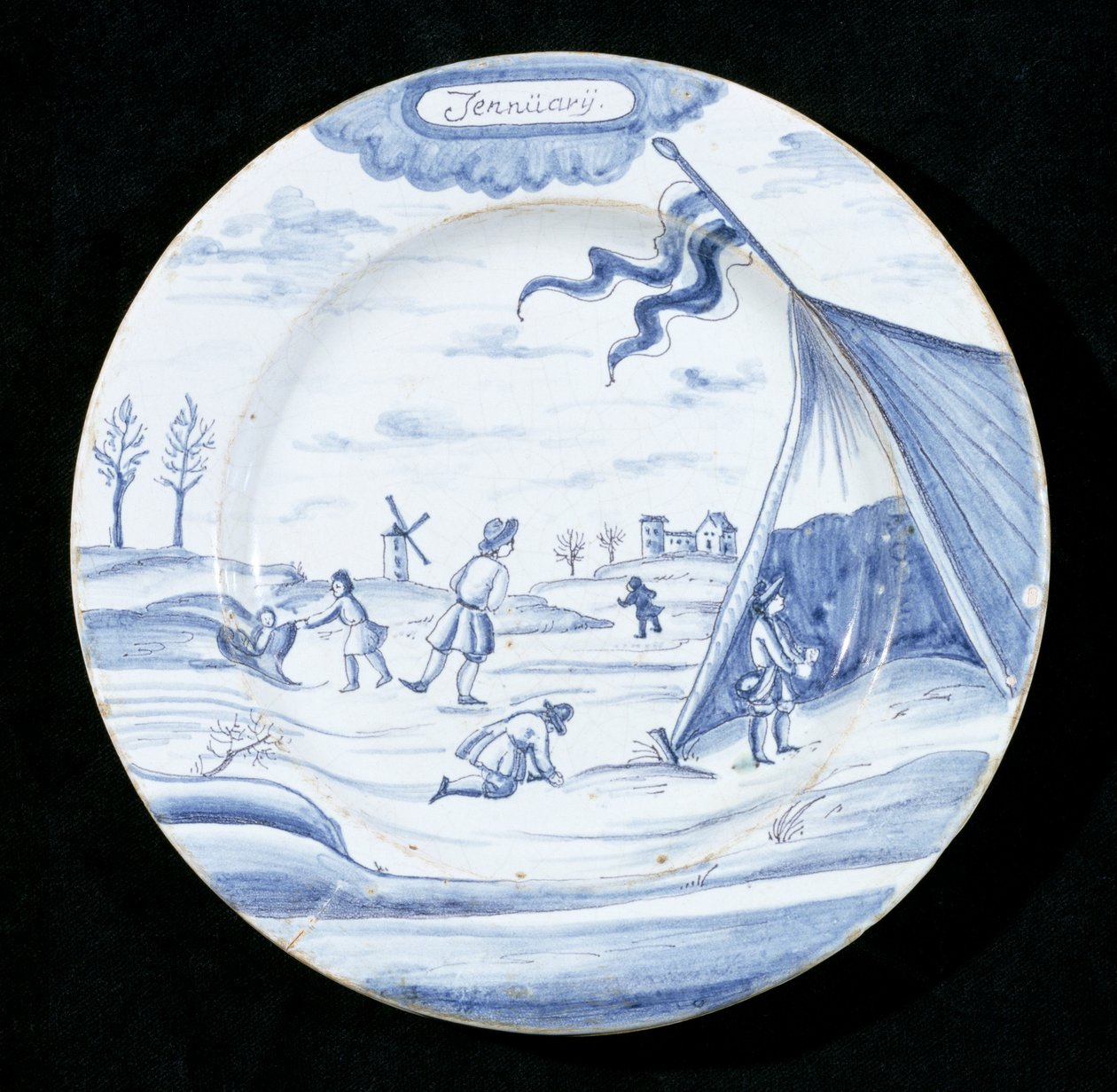 Delftware talíř zobrazující měsíc leden (cínem glazovaná kamenina) od Dutch School