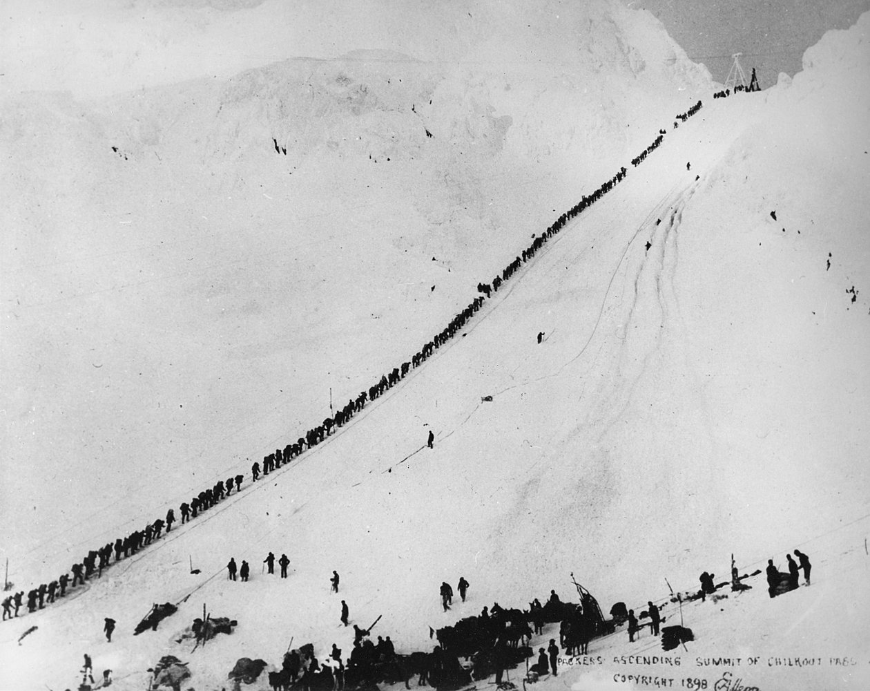 Packers stoupající vrchol Chilkoot Pass, z „One Man