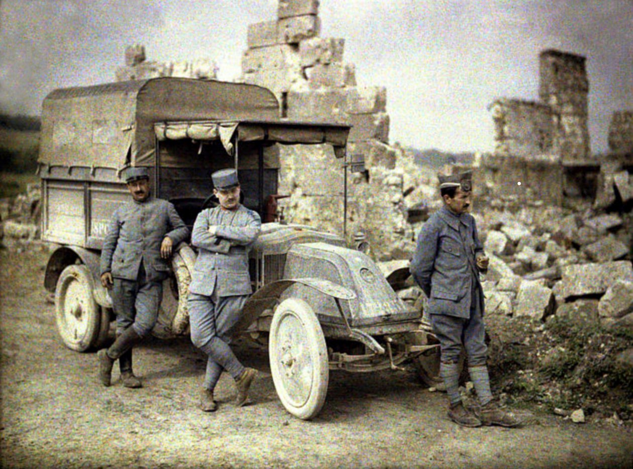 Tři francouzští vojáci parkující s malým nákladním autem před těžce poškozenou budovou, Aisne, Francie, 1917 (autochrom) od Fernand Cuville
