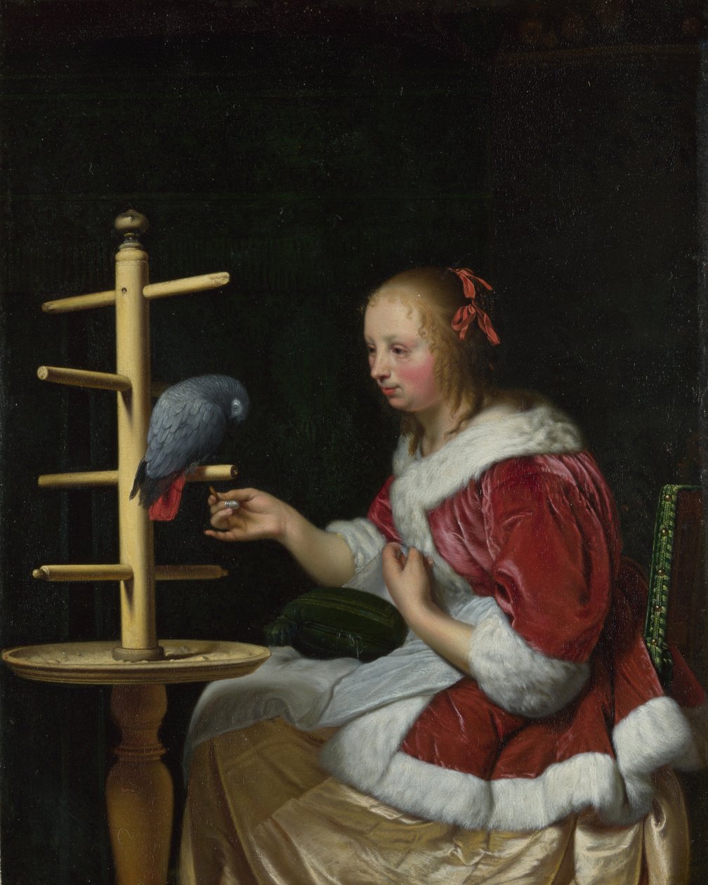 Žena v červené bundě krmící papouška, cca 1663 od Frans van Mieris the Elder