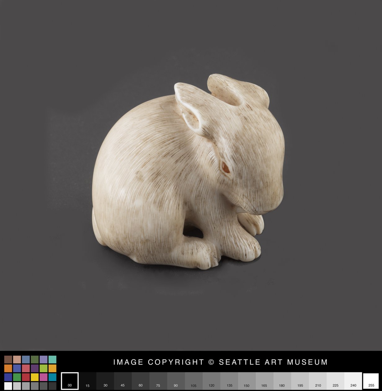 Netsuke vymodelovaný jako zajíc s jantarem oči, konec 19. století (slonovina, jantar) od Japanese School