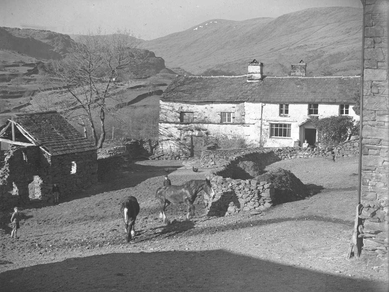 Tři mladí chlapci pozorující koně na dvoře v Kentmere s farmou a údolím za ní od Joseph Hardman