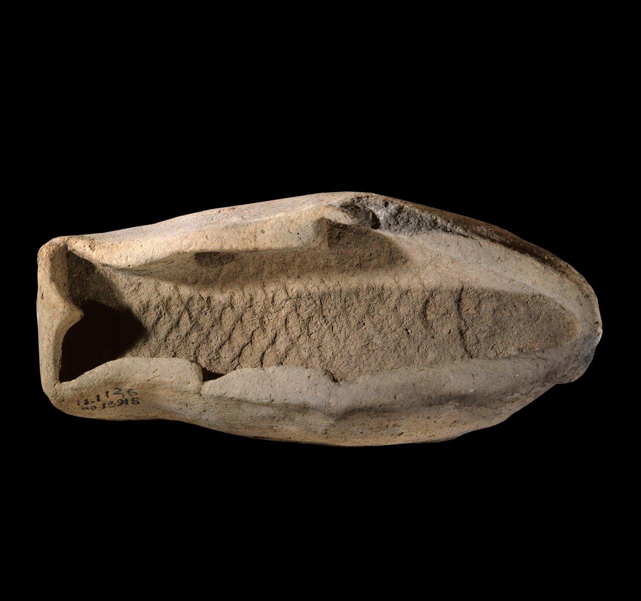 Mezopotámie: terakotová forma ve tvaru ryby. Kolem roku 1800 př.n.l. Z královských jídel paláce krále Zimri Lim v Mari. Paříž, muzeum Louvre od Mesopotamian