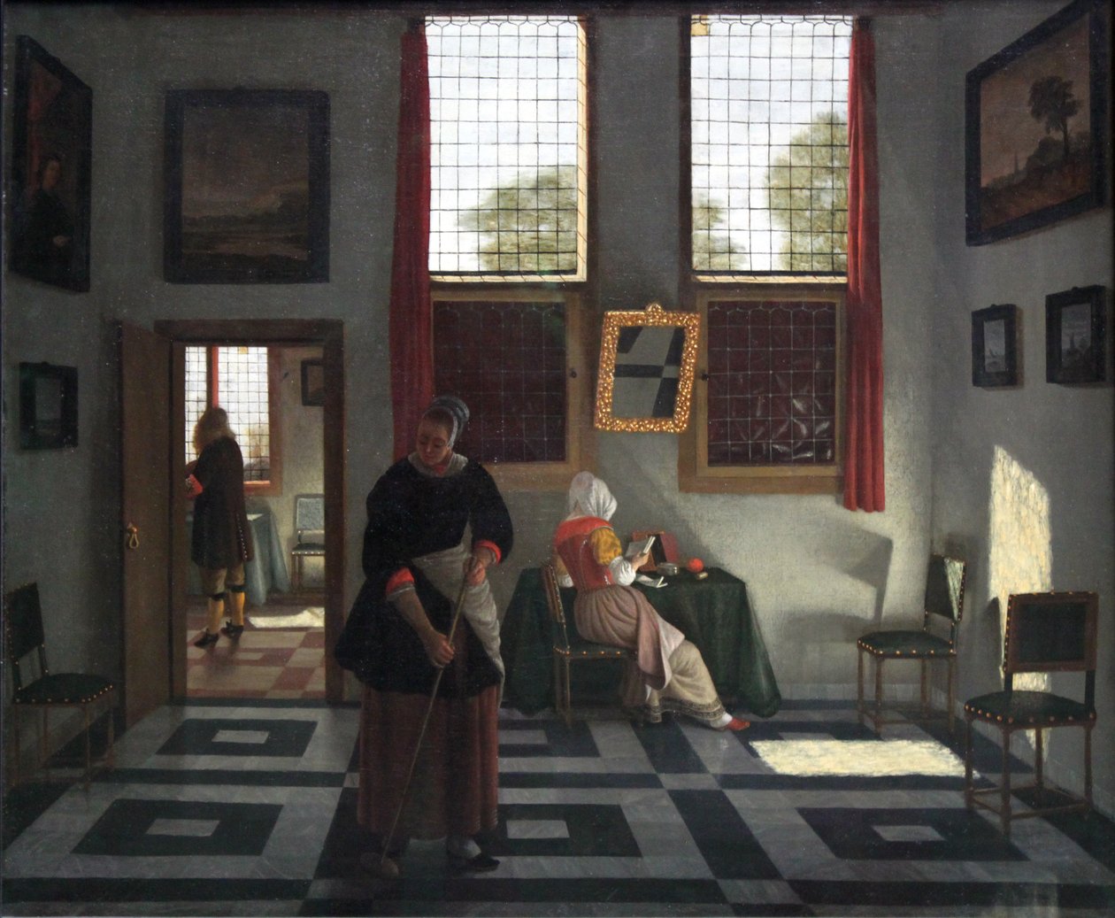 Interiér s malířem, čtoucí paní a zametací služkou od Pieter Janssens