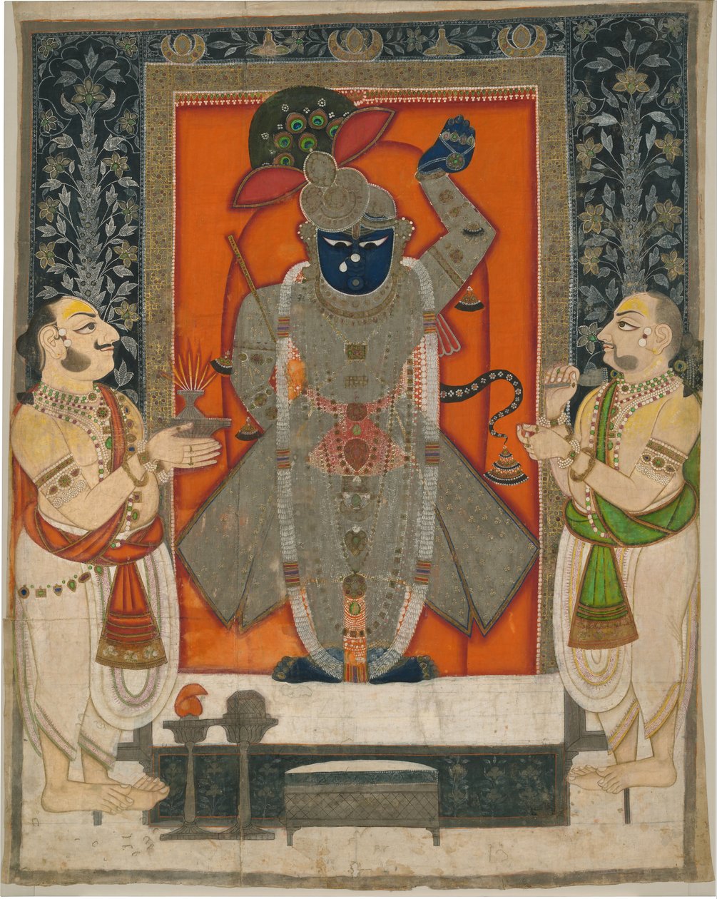 Kněží uctívající Krišnu jako Shrinathji na festivalu Mountain of Food [Annakuta utsava]; svatyně visící [pichhavai] od Rajasthan Kota school