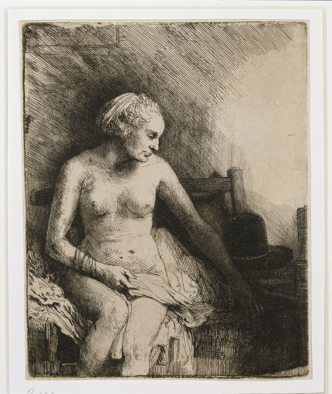 Žena ve vaně s kloboukem vedle ní, 1658 od Rembrandt van Rijn