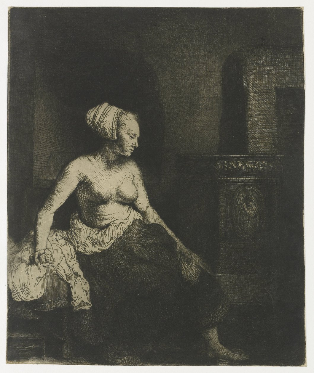 Žena sedí napůl oblečená vedle sporáku od Rembrandt van Rijn