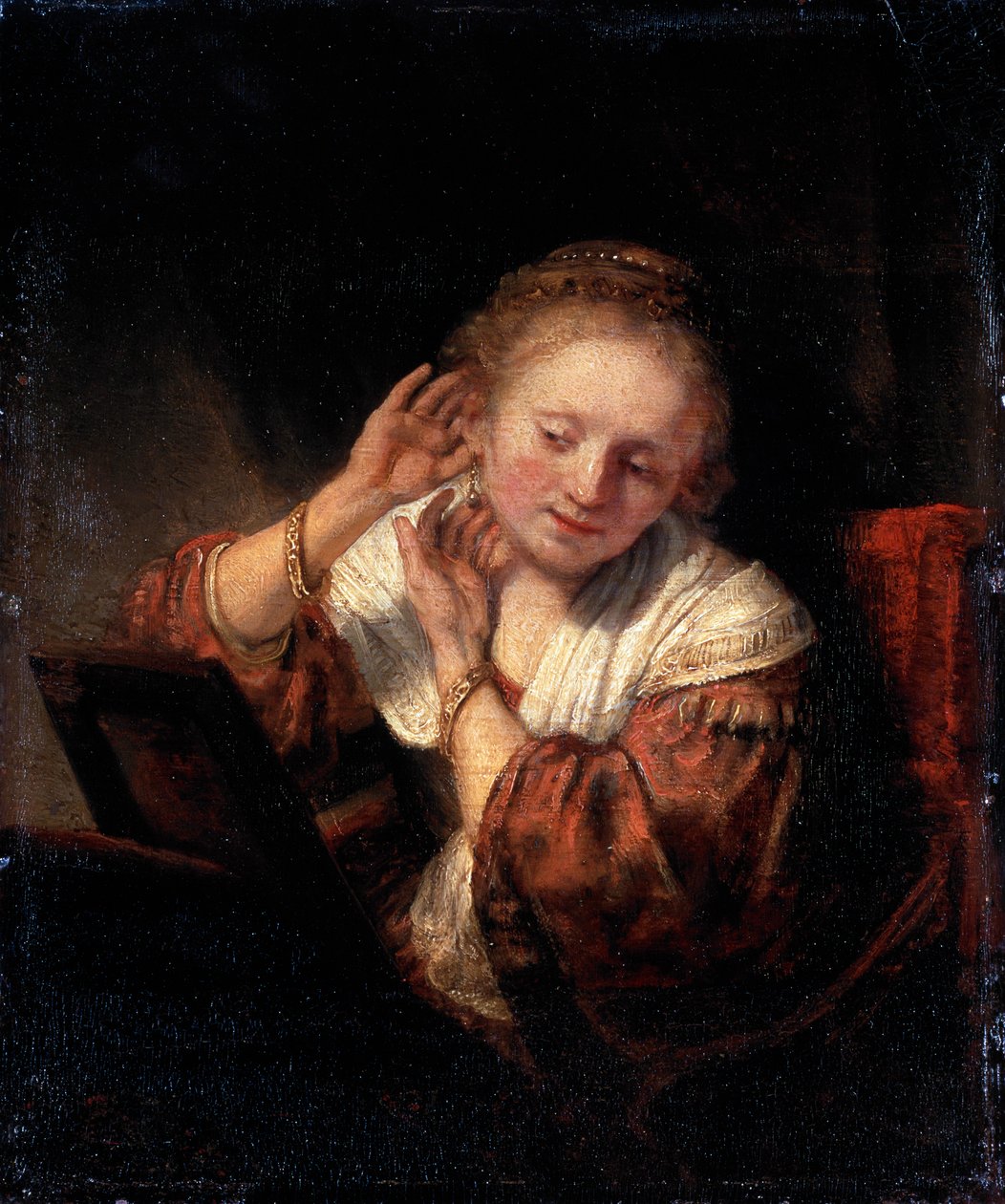 Mladá žena, která si zkouší náušnice, 1657. od Rembrandt van Rijn