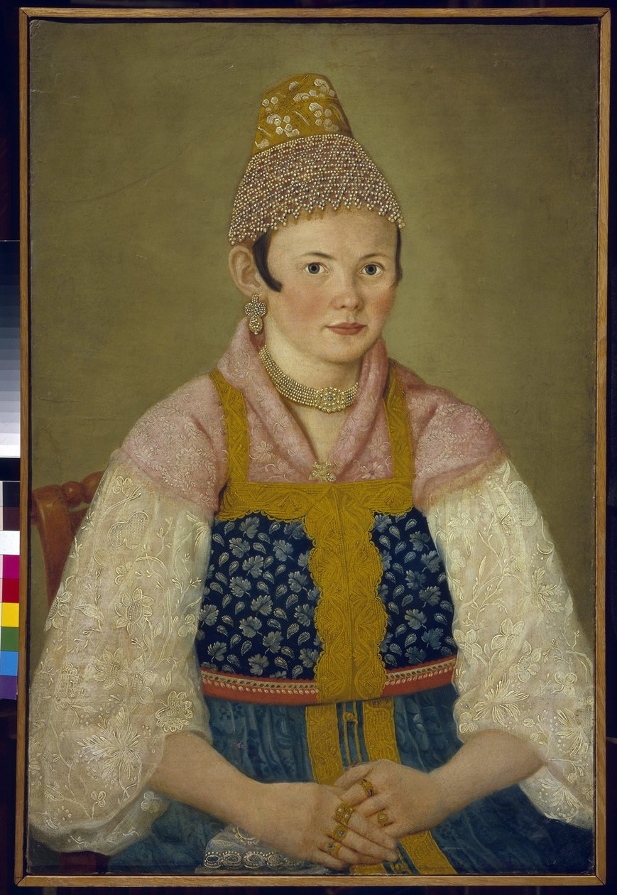 Portrét manželky obchodníka, čelenka tradiční kokoshnik. (Portrét kupecké ženy v Kokoshnik Kabluchok). Nosí také tradiční ruský oděv (sarafán) zdobený výšivkou, s halenkou s krajkovými rukávy, čelenkou od School Russian