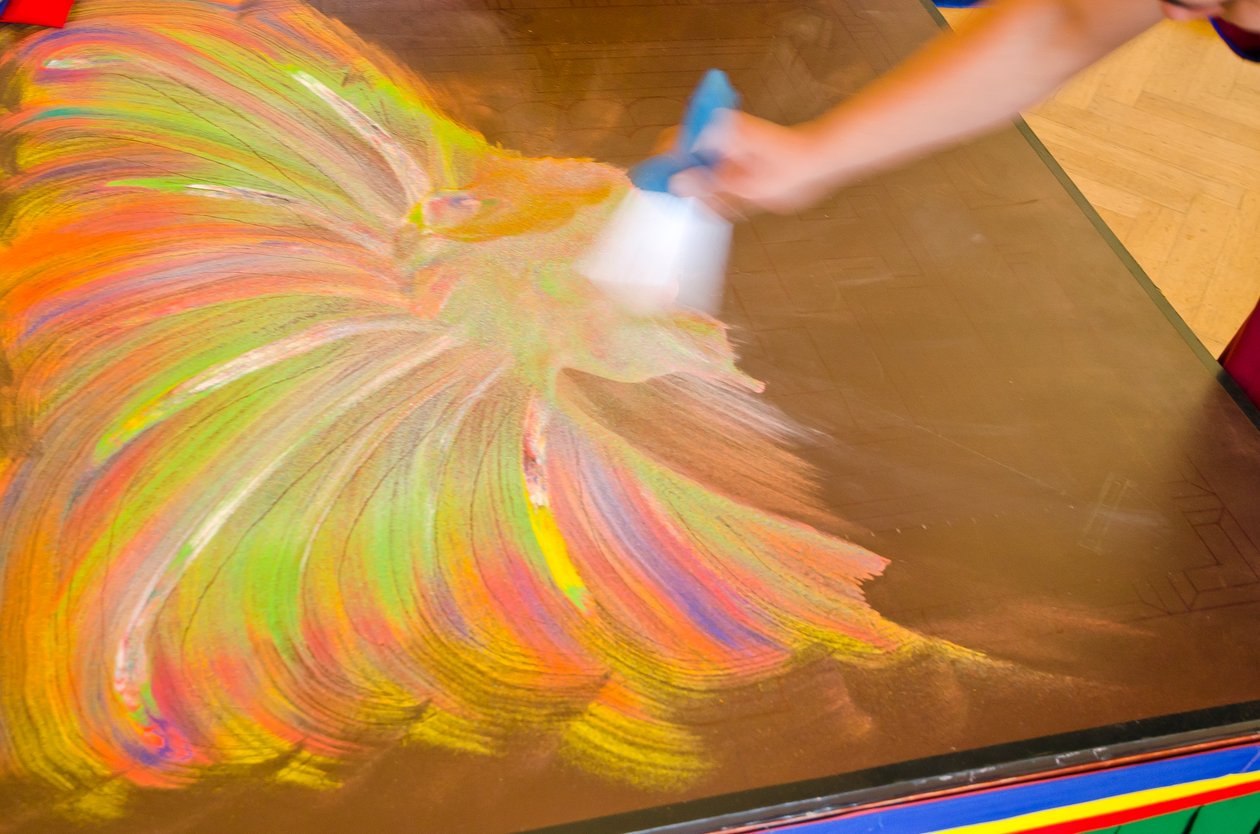 Tibetský buddhistický mnich zametající Medicínský Buddha Sand Mandala po dokončení během fundraisingové návštěvy ve Spojeném království, Swansea, Jižní Wales od Unbekannt Unbekannt
