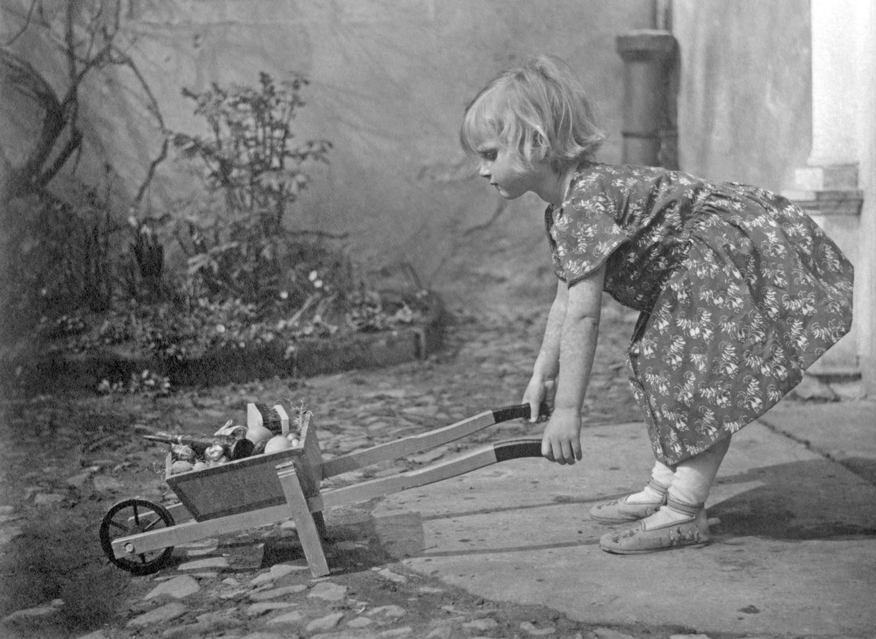 Holčička si hraje s kolečkem. Fotografie kolem roku 1931 od Unbekannt