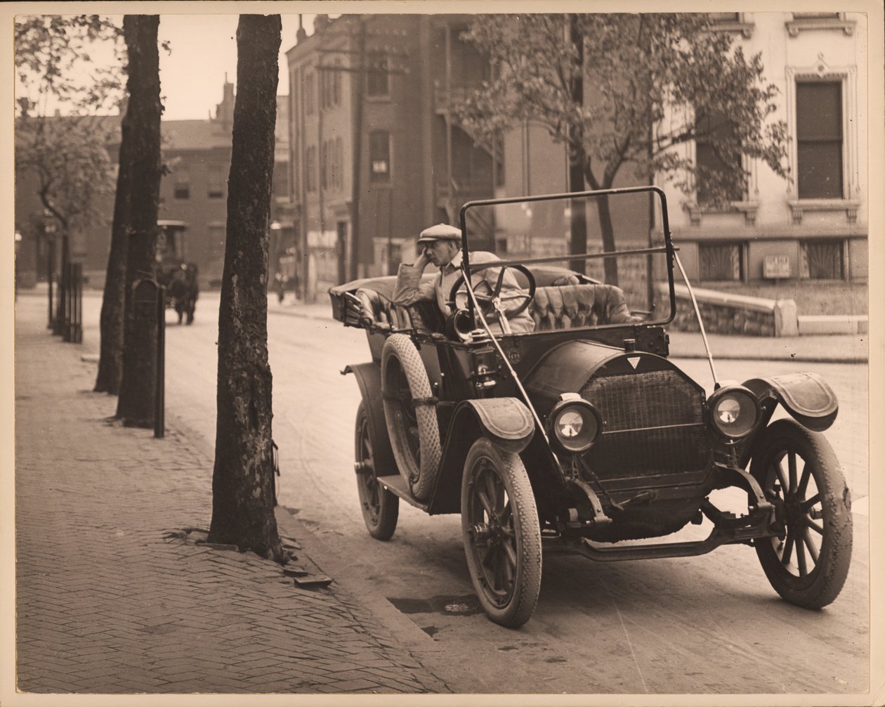Muž sedící v automobilu na neznámé ulici. od William G. Swekosky
