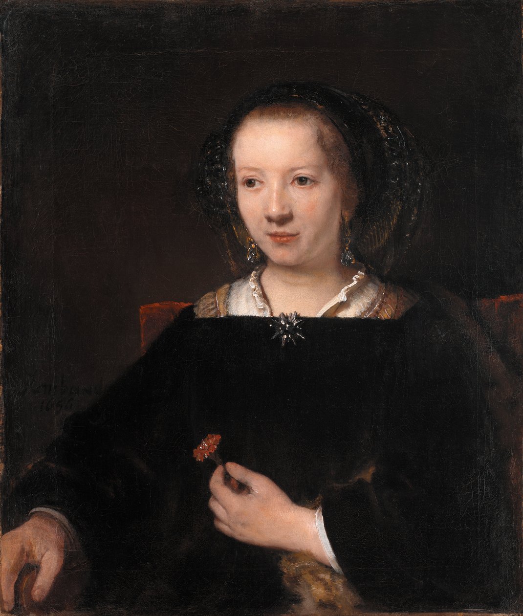 Mladá žena s karafiátem od Workshop of Rembrandt van Rijn