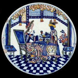 Porcelánový talíř Delft představující ženu u stolu obsluhovaného jejím černým sluhou. 1705 Sevres, Národní muzeum keramiky od Dutch School