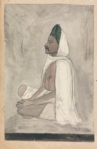 Muž v zeleném turbanu sedí se zkříženýma nohama