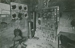 Místnost se stěnami pokrytými graffiti odkazujícími na významné osobnosti současnosti, jako jsou Bussche a Waldow. Pohlednice odeslaná v roce 1913. od German Photographer