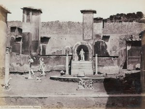 Částečný pohled na vyvýšenou zahradu domu Marca Lucretia v Pompejích, zdobenou mramorovými sochami a hermy. Uprostřed kašna s výklenkem. V pozadí fragmenty nástěnných maleb od Giorgio Sommer