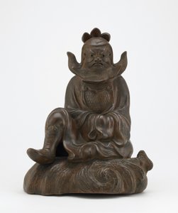 Postava Shokiho, tlumiče démonů, sedícího na skále, Imbe, prefektura Okayama, období Edo nebo éra Meidži (keramika) od Japanese School