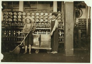 12letý doffer Ronald Webb a 7letý Frank Robinson, syn šéfa kartonáže, který zametá a sundává (vyčistí celé cívky) v Roanoke Cotton Mills, Virginia, 1911 od Lewis Wickes Hine