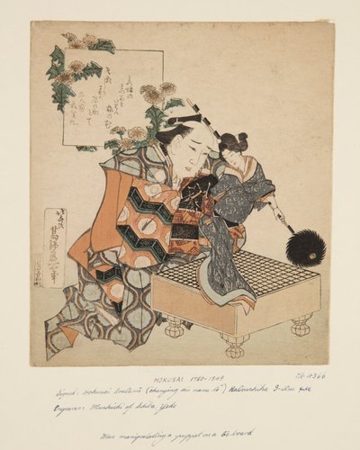 Loutkář držící loutku na desce Go (barevný dřevěný tisk) od Katsushika Hokusai