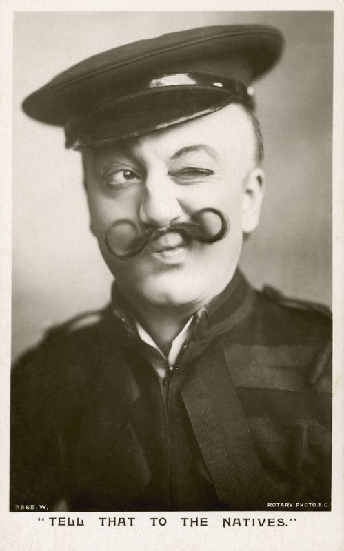 Žena v uniformě s knírkem (černobílá fotografie) od English Photographer