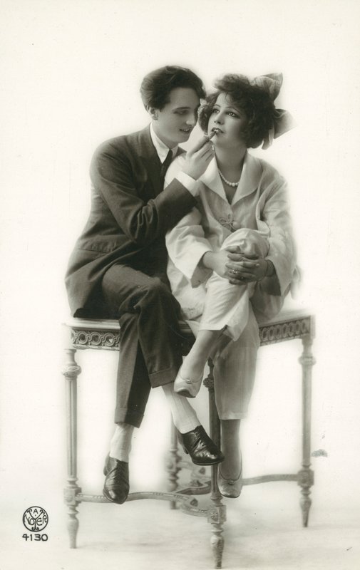 Androgynní muž v obleku nanášení rtěnky na rty dívky v pyžamu od French Photographer