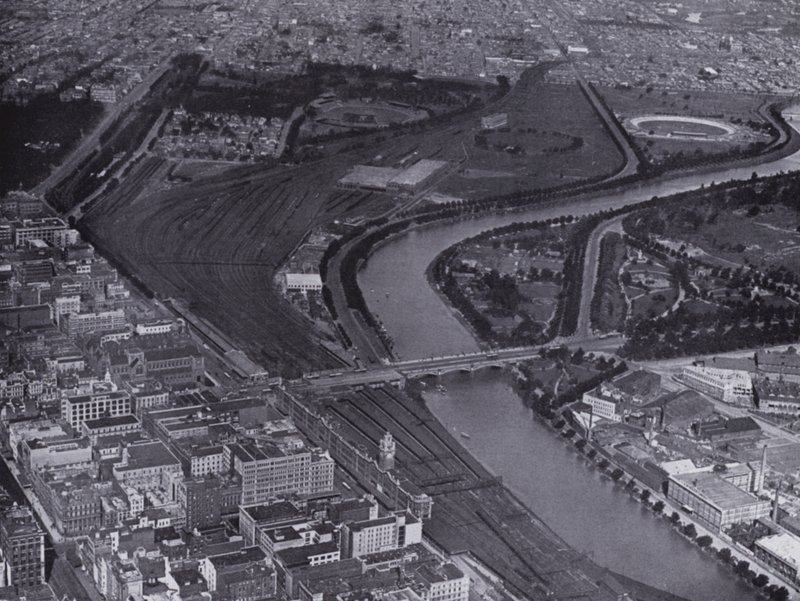 Melbourne: Letecký pohled na Jolimont Railway Yards a řeku Yarra, ukazující malou část města a Richmond v dálce (černobílá fotografie) od Photographer Australian