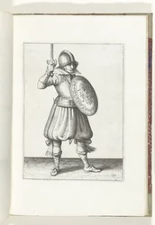 Cvičení The Shield and Spike: The Soldier prezentuje svůj rapír rukou ne výš než jeho tvář (č. 19), 1618 Nassausche Wapen-Handelinge, van Schilt, Spies, Rappier a Targe: beyde figuerlick vyobrazen a zarámovaný podle nového řádu