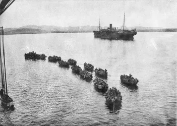 Australští vojáci jsou taženi na břeh v zapalovačích, aby přistáli v Anzac Cove, Gallipoli. V pozadí je transportní loď, 1915