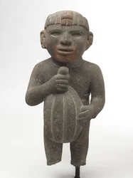 Muž nesoucí kakaový lusk, 1440-1521 (sopečný kámen se stopami červeného pigmentu)