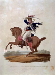 Desátník 10. královského husarského pluku prince z Walesu v přehlídkovém řádu, z knihy "Costumes of the Army of the British Empire, according to the last regulations 1812", vyryl J. C. Stadler, pub.