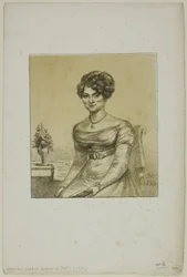 Žena sedící před stolem