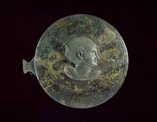Litý bronzový zrcadlový kryt s helénistickou bustou ženy v reliéfu, 100 př. n. l. - 100 n. l. (litý bronz s vroubkovaným zdobením)