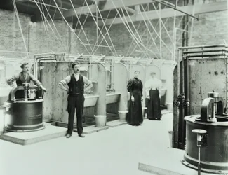 Boundary Street: interiér prádelny, lidé pracující se stroji, Londýn, 1897