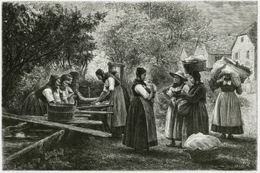 Prádelna v Metzeral, ženy v tradičních údolních krojích se scházejí u vesnické kašny. Rytina E.Ronjata k ilustraci příběhu „Atravers l
