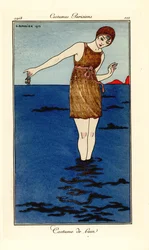 Žena v plavkách až po kotníky v moři na pláži drží kraba. Kostým de bain. Ručně kolorovaný pochoir (šablona) lept podle ilustrace George Barbiera z Tommasa Antonginiho Journal des Dames et des Modes, Aux Bureaux du Journal