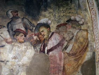 Voják v brnění a muži v klobouku, detail fresky od Girolama Romanina (asi 1484-po 1562), levá stěna presbytáře kostela sv. Antonína opata, Breno. Itálie