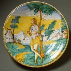 Hráč na flétnu v krajině. Keramický talíř vyrobený ve Viterbu, Itálie. Konec 16. století, Florencie, Museo Nazionale del Bargello