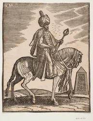 Jezdec v turbanu s mečem u pravého boku a válečným kyjem v levé ruce, profil vpravo; v pozadí obelisk