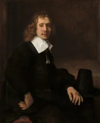 Mladý muž sedící u stolu pravděpodobně Govaert Flinck, c. 1660.