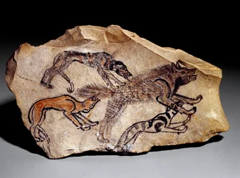 Psi lovící hyenu (kamenná rytina, asi 1300-1100 př. n. l.)