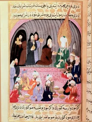 Prorok Muhammad (Muhammad nebo Muhammad) (570-632) se zahalenou tváří je na cestě do Sýrie uvítán křesťanskými mnichy, kteří mu podávají jídlo. Turecká miniatura z 18. století. Muzeum Topkapi, Istanbul, Turecko