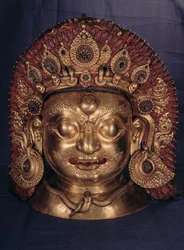 Hlava Bhairavy, konec 17. století (ražená měď, malovaná a zlacená)
