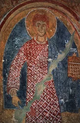 Postava světce, freska v kapli svatého Mikuláše (11.-15. století), Mottola, Puglia, Itálie